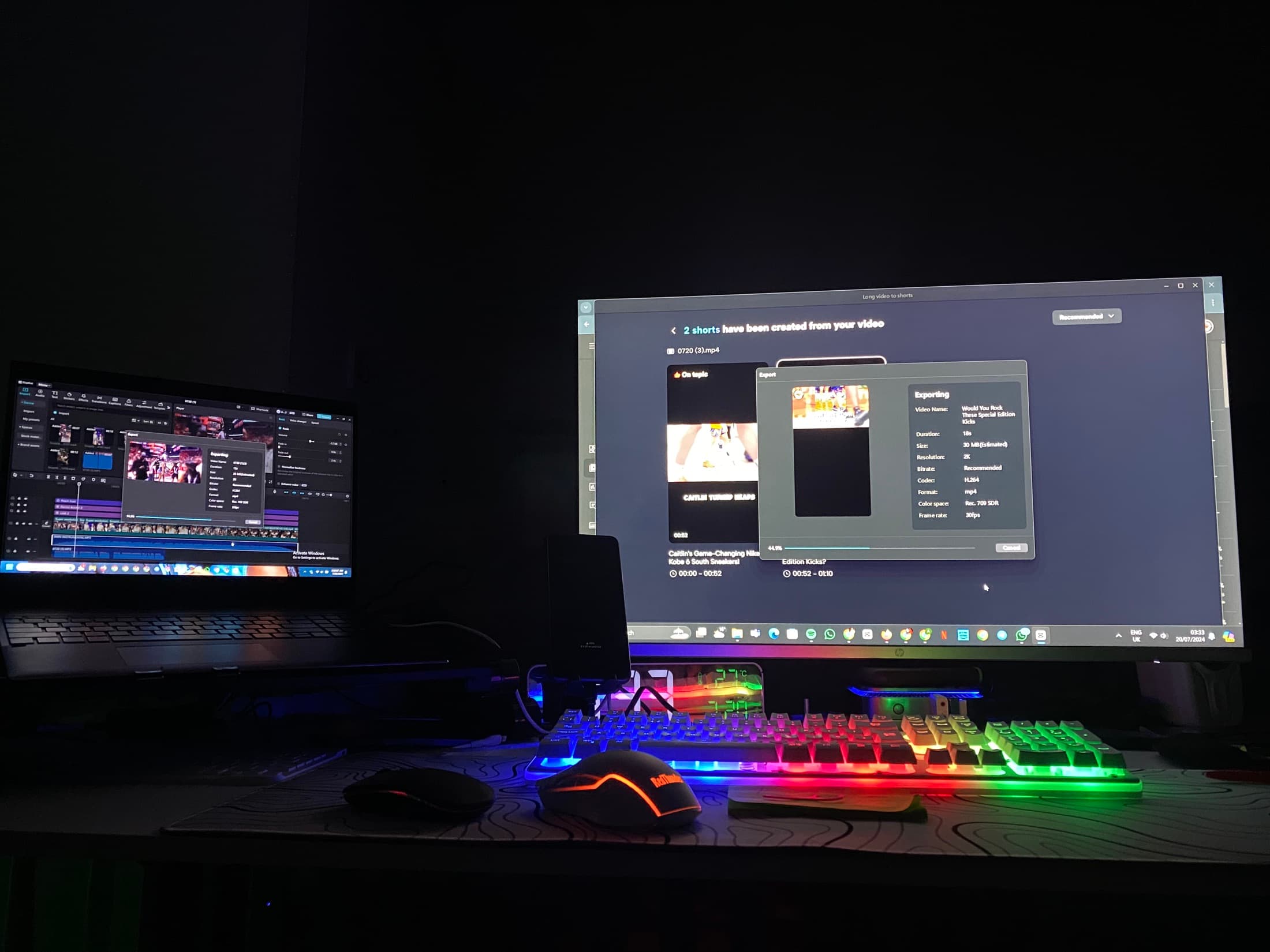 A dark edit bay with a laptop timeline and a monitor exporting a video
